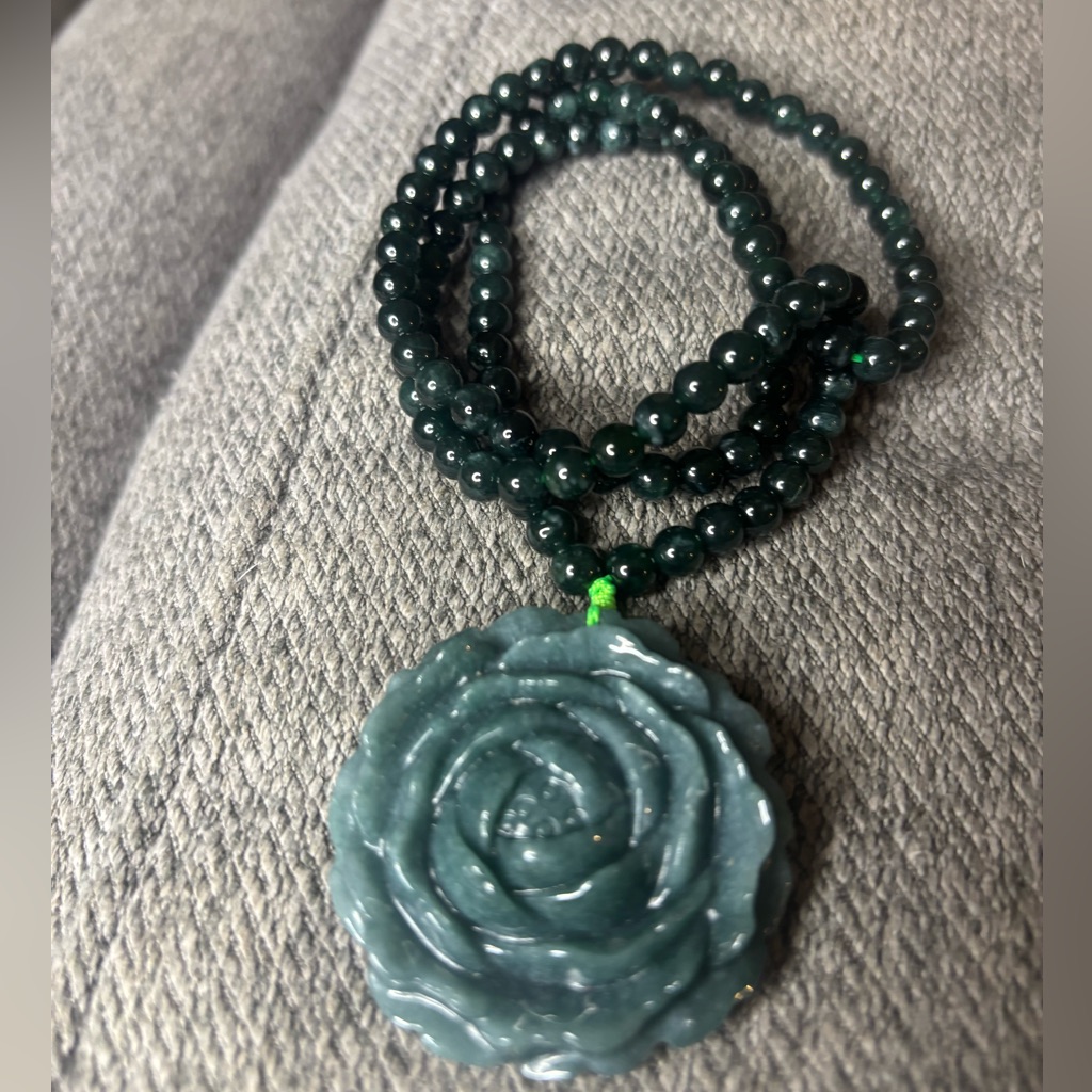 A jadeite beaded necklace with a lotus pendant listed at $150.00 on a US resale marketplace in September 2026